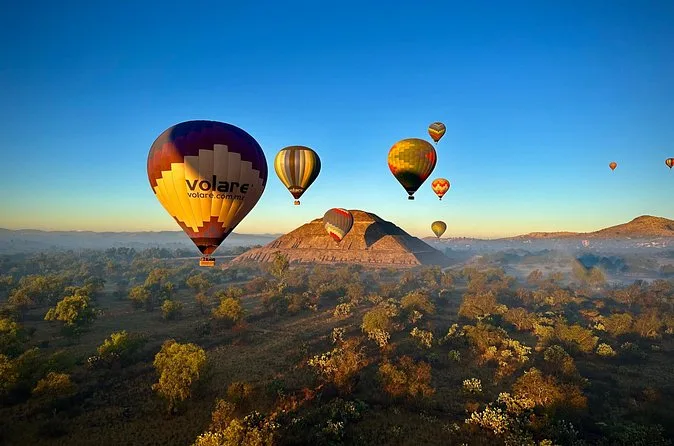 Balloons drifting above the plain with the Pyramid of the Sun